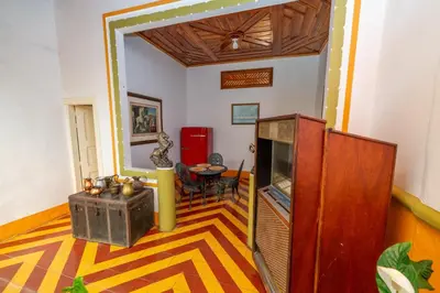 a living room with a television and a table at Casa Hotel Santa Laura Jericó in Jericó
