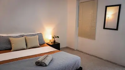 a bedroom with a bed with two towels on it at Casa MoraZ in Medellín
