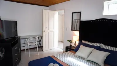 a bedroom with a bed and a television in it at Casa MoraZ in Medellín