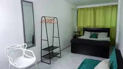 a bedroom with a bed and a ladder next to a mirror at Casa MoraZ in Medellín