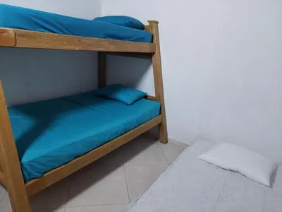 two bunk beds with blue sheets in a room at San Antonio in El Peñol