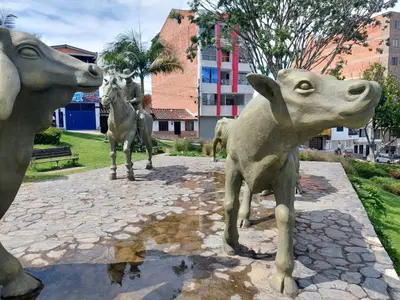 a statue of a cow and a horse at San Antonio in El Peñol