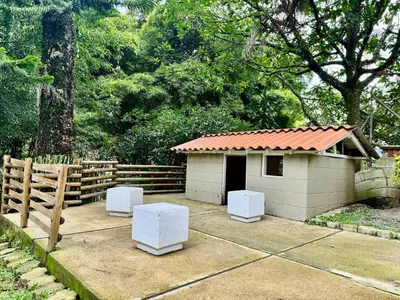 a small building with two white stools in a yard at 4BR 240 m² Pool Next to El Tesoro Mall in Medellín