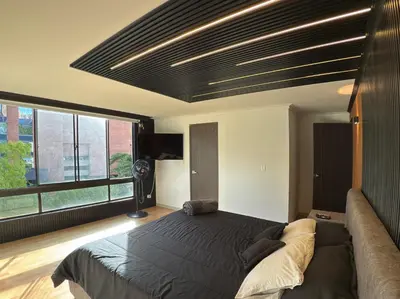 a bedroom with a large bed and a large window at 4BR 240 m² Pool Next to El Tesoro Mall in Medellín