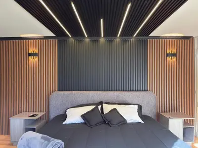 a bedroom with a bed with two night stands and lights at 4BR 240 m² Pool Next to El Tesoro Mall in Medellín