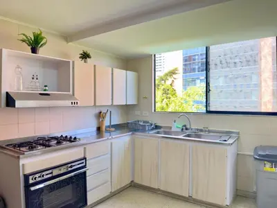 a kitchen with a stove and a sink and a window at 4BR 240 m² Pool Next to El Tesoro Mall in Medellín