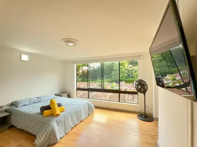 a bedroom with a bed with a teddy bear on it at 4BR 240 m² Pool Next to El Tesoro Mall in Medellín