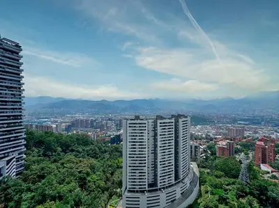 a view of a city with a tall building at 3BR Panoramic Near Country Club El Poblado in Medellín