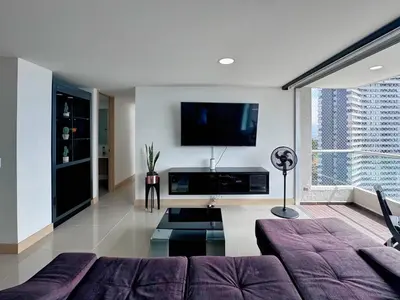 a living room with a couch and a flat screen tv at 3BR Panoramic Near Country Club El Poblado in Medellín