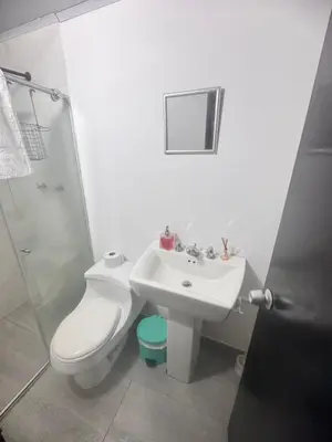 a bathroom with a toilet and a sink and a shower at Urbanhost in Manizales