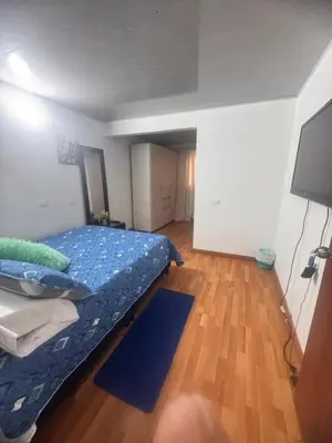 a bedroom with a bed and a television in it at Urbanhost in Manizales