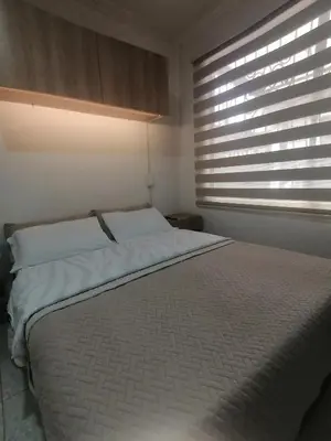 a bedroom with a large bed with a window at Apartamento Aeropuerto Rionegro in Rionegro