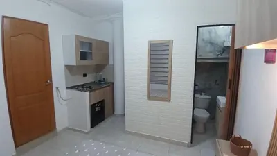 a bathroom with a toilet and a sink and a mirror at Apartamento Aeropuerto Rionegro in Rionegro