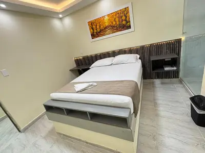a bedroom with a bed in a room at Hotel Magistral Suiter in Quibdó