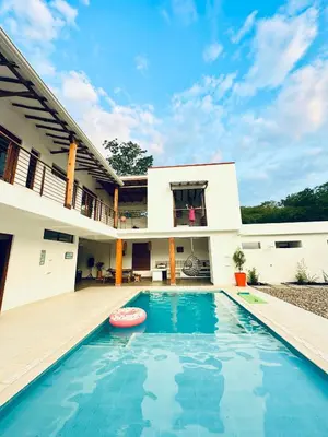 a swimming pool in front of a house at Villa Paulina in Honda