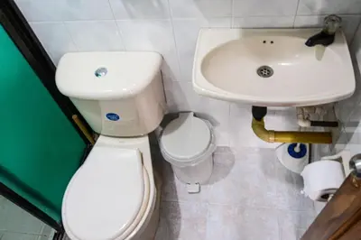 a bathroom with a toilet and a sink at Apto Acogedor Cerca Metrocable in Medellín