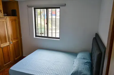 a bed in a room with a window at Apto Acogedor Cerca Metrocable in Medellín