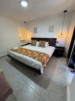 a bedroom with a large bed in a room at Hotel Volcán Campestre Guatapé in Guatapé