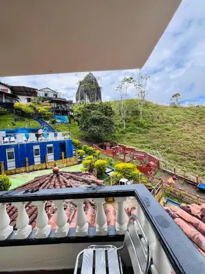 a balcony with a view of a playground at Hotel Volcán Campestre Guatapé in Guatapé