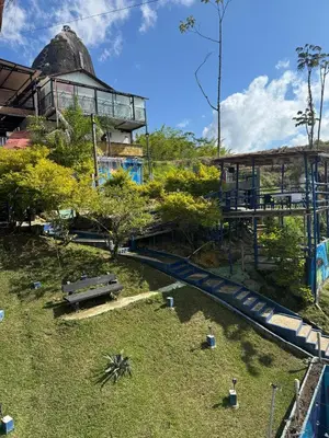 a water slide in a park with a building at Hotel Volcán Campestre Guatapé in Guatapé