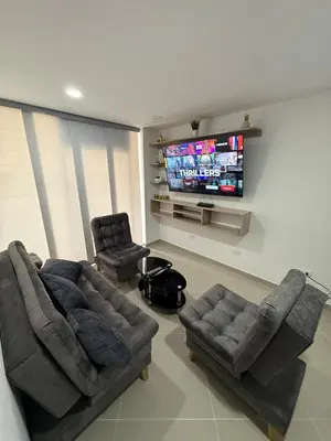 a living room with two couches and a flat screen tv at 201New apartment perfect location Close to poblado in Medellín