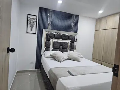 a bedroom with a large bed with white sheets and pillows at 201New apartment perfect location Close to poblado in Medellín