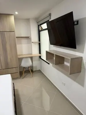 a living room with a flat screen tv on a wall at 201New apartment perfect location Close to poblado in Medellín