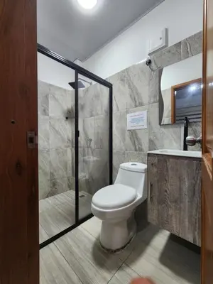 a bathroom with a toilet and a shower and a sink at Hotel tranquilandia La 14 in La Dorada