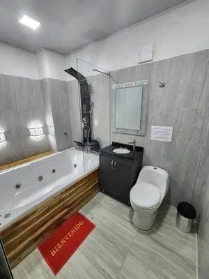a bathroom with a tub and a toilet and a sink at Hotel tranquilandia La 14 in La Dorada