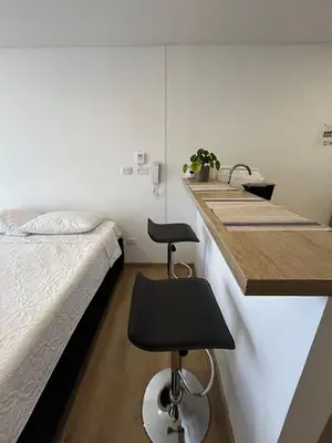 a bedroom with a bed and a kitchen with a sink at Sofisticado con Ubicación privilegiada - Estrato 5 in Manizales