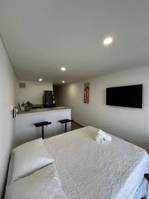 a bedroom with a bed and a flat screen tv at Sofisticado con Ubicación privilegiada - Estrato 5 in Manizales
