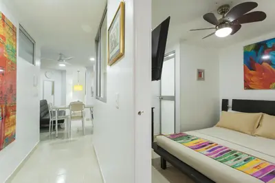 a bedroom with a bed and a ceiling fan at Apartamentos Amoblados JG de la 70 in Medellín