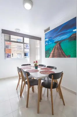 a dining room with a table and chairs at Apartamentos Amoblados JG de la 70 in Medellín