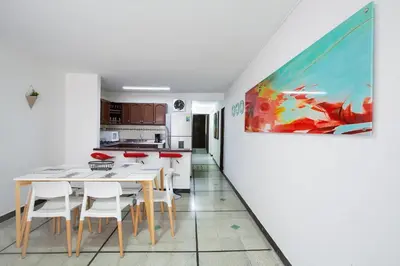 a kitchen and dining room with a painting on the wall at Apartamentos Amoblados JG de la 70 in Medellín