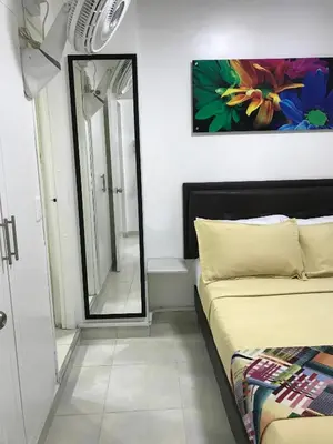 a small bedroom with a mirror and a bed at Apartamentos Amoblados JG de la 70 in Medellín