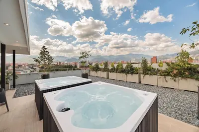 a jacuzzi tub on the roof of a building at Quadrato Studios in Medellín