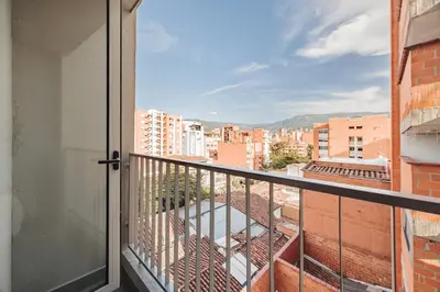 a balcony with a view of a city at Quadrato Studios in Medellín
