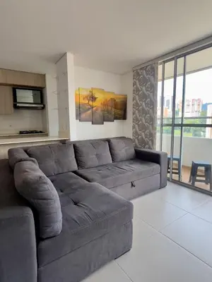 a living room with a gray couch in a room at Apartamento moderno y acogedor en el corazón de Sabaneta in Sabaneta