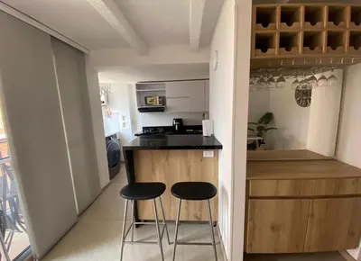 a small kitchen with two stools at a counter at Lindo Apartamento Amoblado en buen sector en Sabaneta in Sabaneta