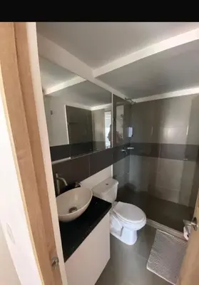 a bathroom with a sink and a toilet and a mirror at Lindo Apartamento Amoblado en buen sector en Sabaneta in Sabaneta