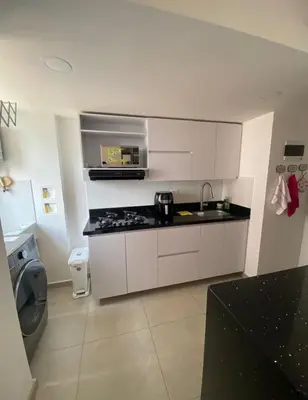 a kitchen with white cabinets and a sink and a stove at Lindo Apartamento Amoblado en buen sector en Sabaneta in Sabaneta