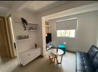 a living room with a couch and a table at Lindo Apartamento Amoblado en buen sector en Sabaneta in Sabaneta