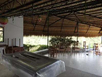 a large pavilion with tables and chairs in a room at Finca la Irlanda in Manizales