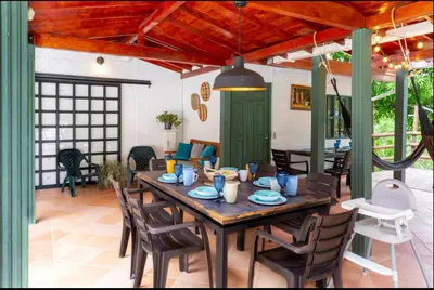a dining room with a wooden table and chairs at Espectacular finca Familiar en sopetran Antioquia in Sopetran