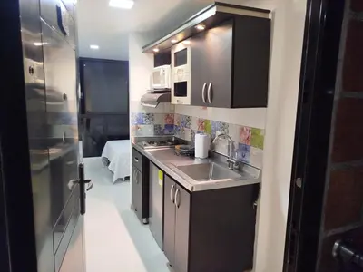 a small kitchen with a sink and a microwave at Apartamento en Belén in Medellín