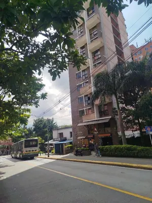 a bus is parked on the side of a street at Apartamento en Belén in Medellín