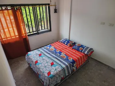 a small bed in a room with a window at Augusto Hernandez in Santa Fe de Antioquia