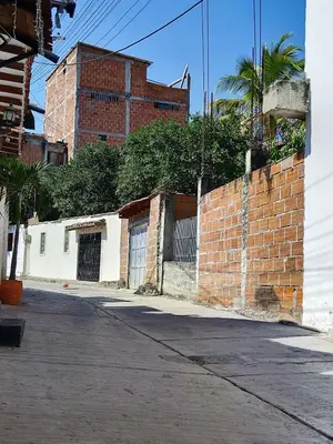 an empty street with a brick wall and a building at Augusto Hernandez in Santa Fe de Antioquia