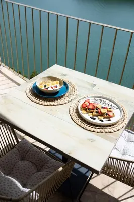 a wooden table with two plates of food on it at MYLOS Hotel Boutique in Guatapé
