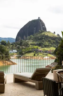 a room with a couch and a view of a mountain at MYLOS Hotel Boutique in Guatapé